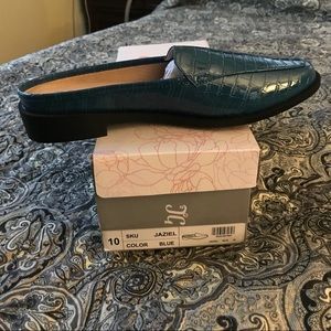 Turquoise blue croc slides.